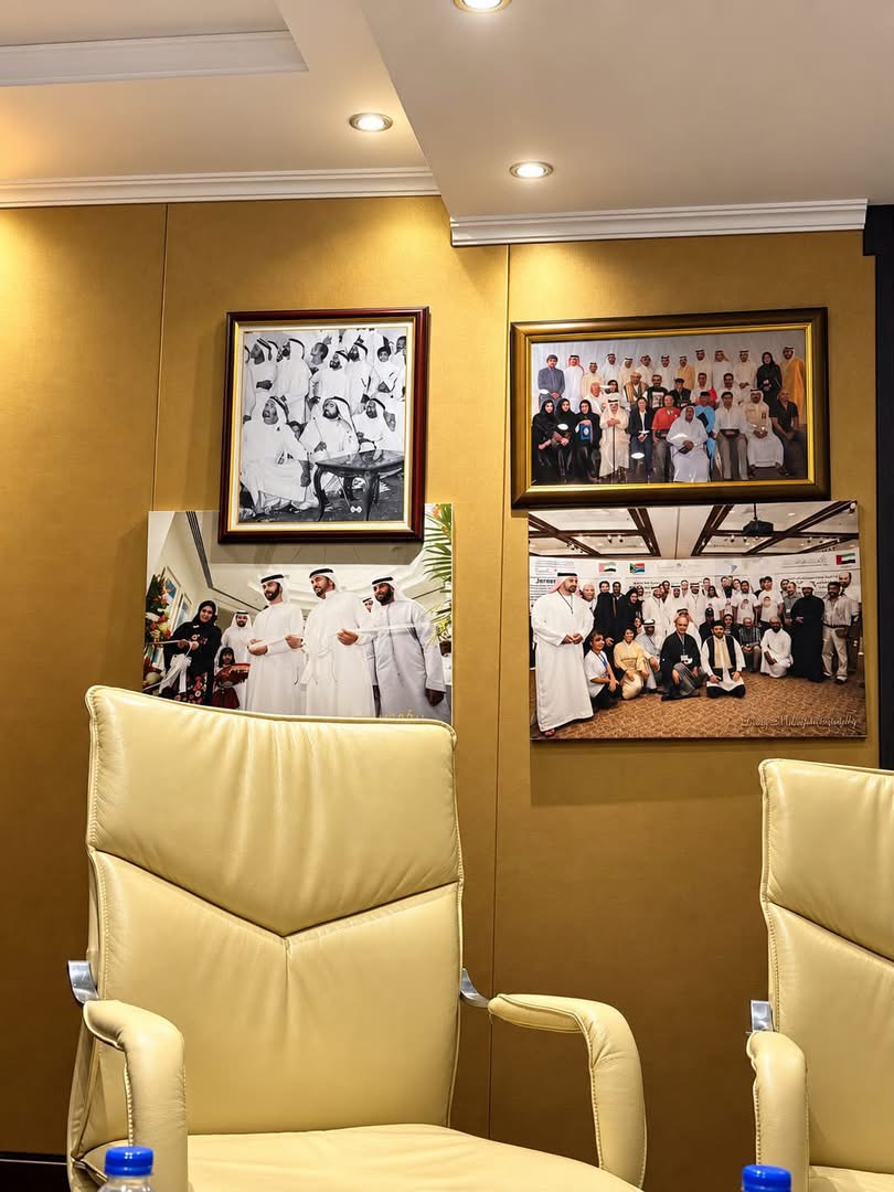 Meeting room with photographs of past events on the wall.